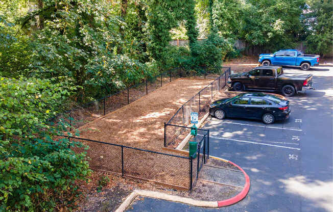 A black car is parked in a parking lot.