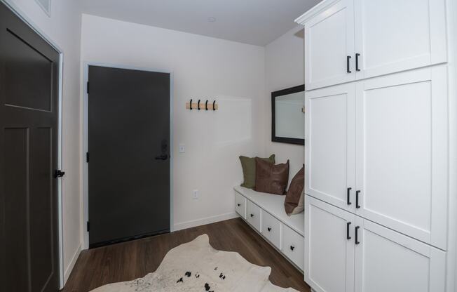 a room with white cabinets and a white couch and a black door at The Crossings at Windsong, Prescott Valley, Arizona