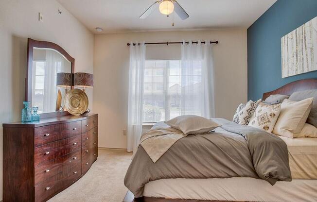 a bedroom with carpet, ceiling fan, and window