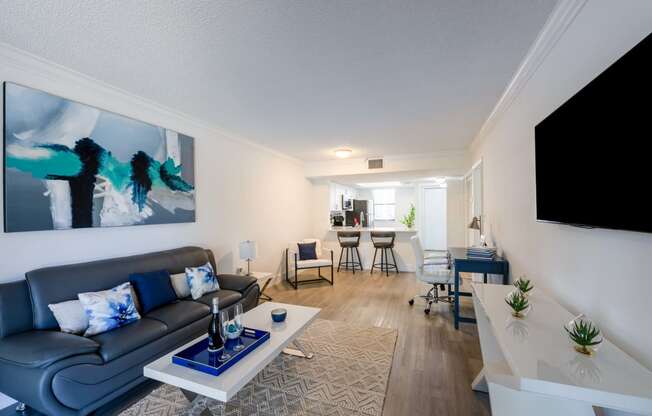 Apartments In Coconut Creek for Rent – Waterview at Coconut Creek – living room with a couch and a table and hardwood floors