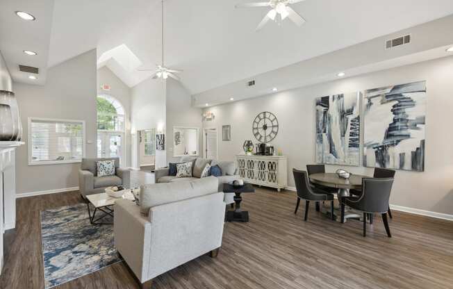 a living room with couches and chairs and a dining room table