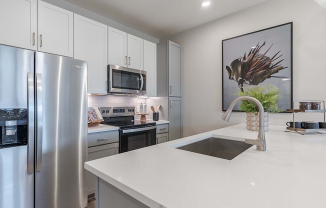Madison, AL, Luxury Apartments - Paxton Place - Kitchen with Quartz Countertops, Stainless Steel Appliances, and Two-Toned Cabinetry.