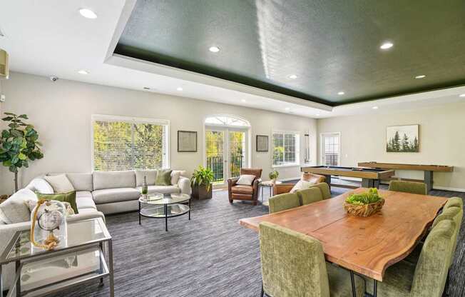 Clubhouse with a pool table and grey chairs.