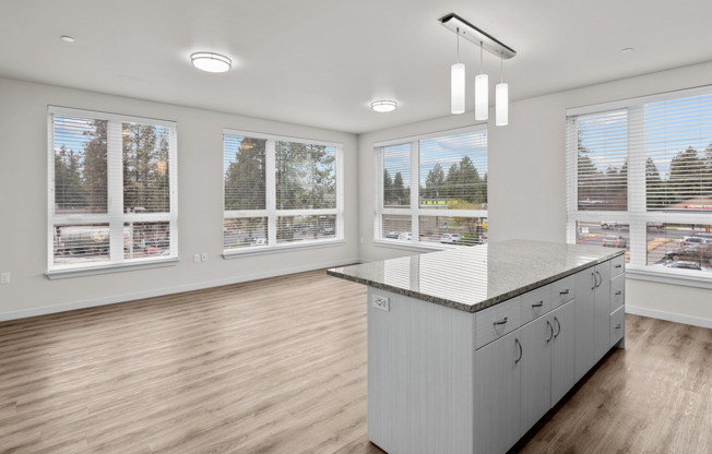 large open kitchen and living area with panoramic floor to ceiling windows and kitchen island