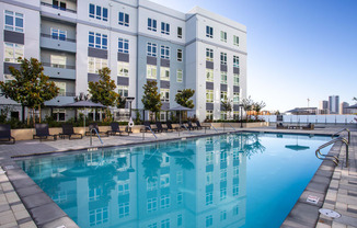 a large swimming pool in front of an apartment building