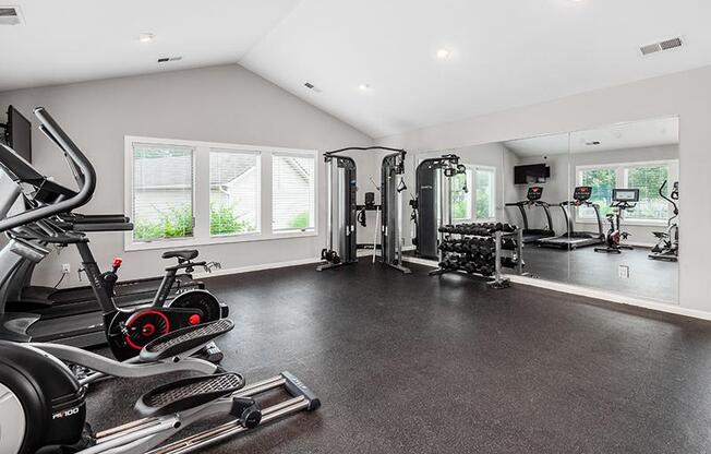A spacious home gym with a variety of exercise equipment.
