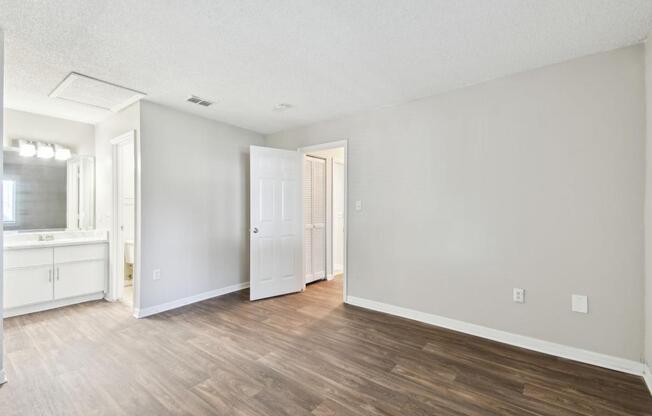 the spacious living room and kitchen of an apartment