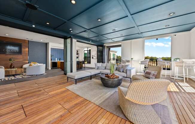 A modern living room with a wooden floor and a large window.
