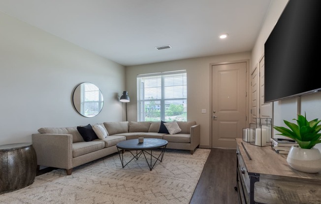 a living room with a couch and a table and a tv