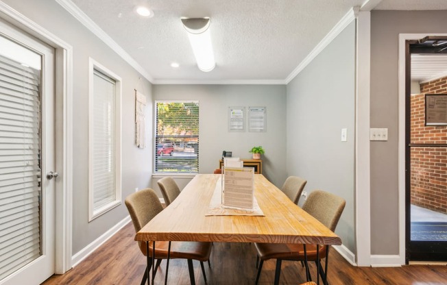 a dining room with a wooden table and chairs