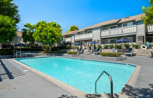 a swimming pool with a building in the background