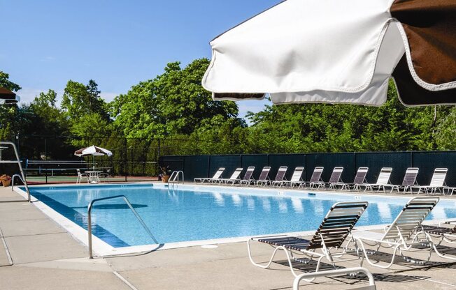 Outdoor Pool with Lounge chairs on the deck at Hillcrest Village, Holbrook, NY, 11741