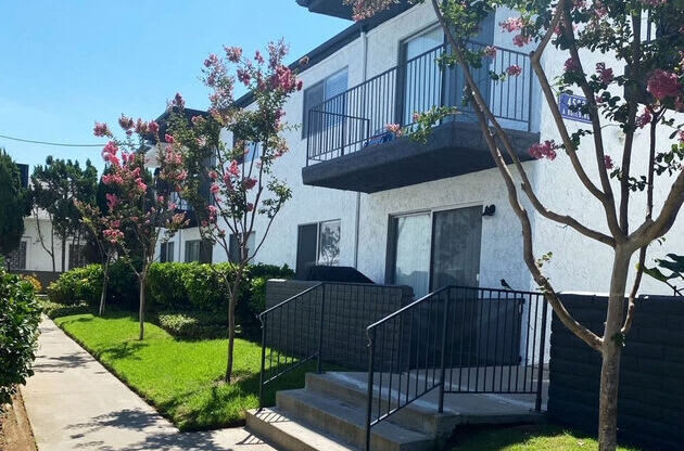 a white house with a sidewalk in front of it at Latitude Apartments at Mission Valley, San Diego, CA 92120