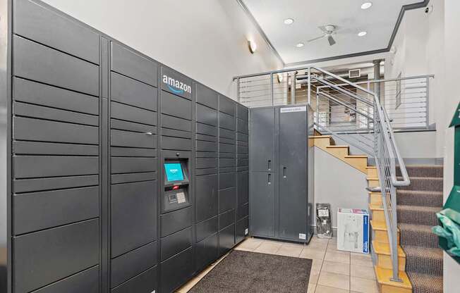 A row of Amazon lockers are lined up in a hallway.