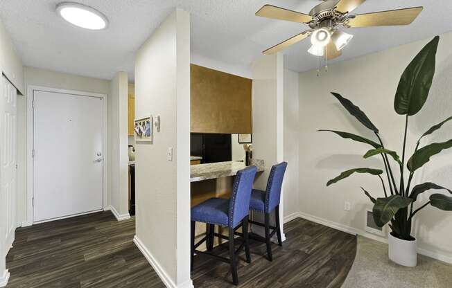 a dining area with a table and chairs and a ceiling fan at Pacific Park Apartment Homes, Edmonds