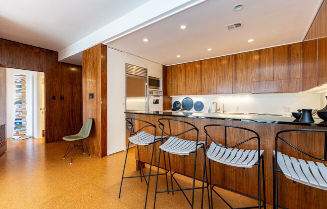 Meticulously maintained 1br + office apartment featuring original 1961 design elements, 24-hour doorman, covered garage parking w/ EV charger and storage.