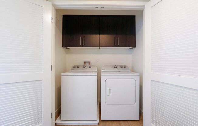 a laundry room with two washes and a dryer in it