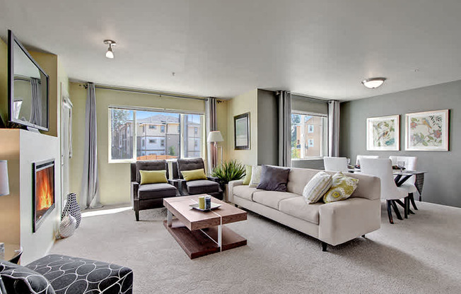 A living room with a fireplace and a couch. at Mill Creek Meadows Apartments, Mill Creek, WA