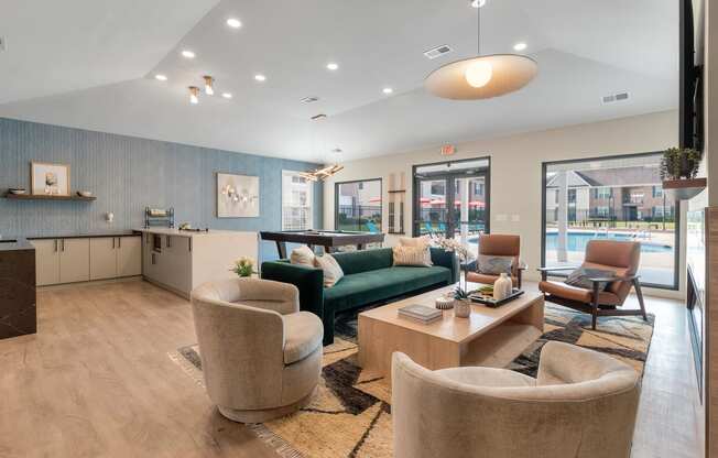 a living room with couches and chairs and a kitchen