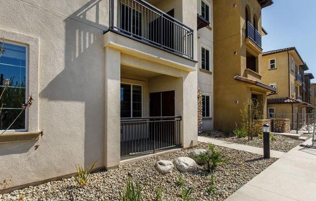 Outside apartment are rocks and plants