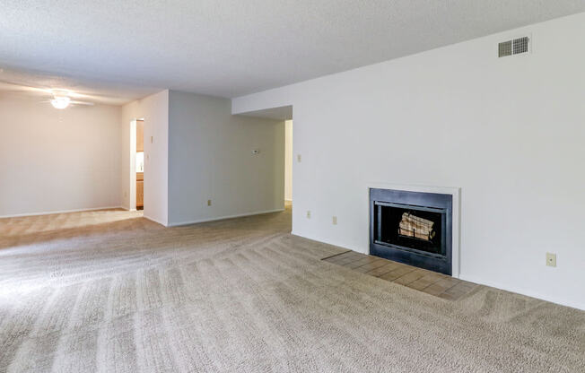 Living space at Ashley Pointe Apartments with a wood burning fireplace