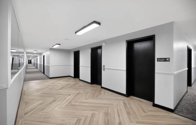 Welcome to The Jefferson, an Eagle Rock Community. Explore modern hallways featuring sleek black doors and elegant flooring designed for comfort and style. Elevate your lifestyle today—schedule a tour to see your new home!