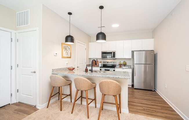 a kitchen with a marble counter top and bar stools