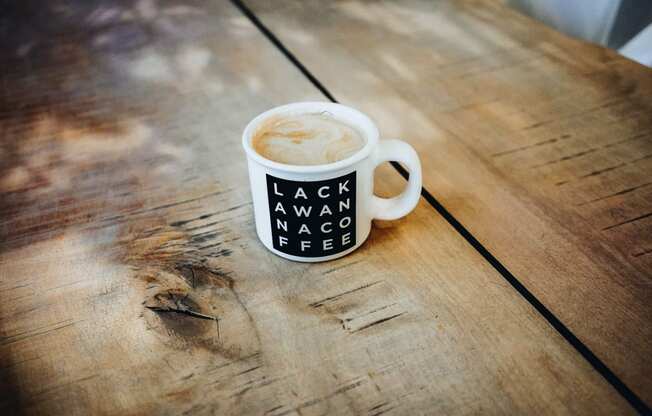 a cup of coffee on a wooden table at The Lively, New Jersey, 07302