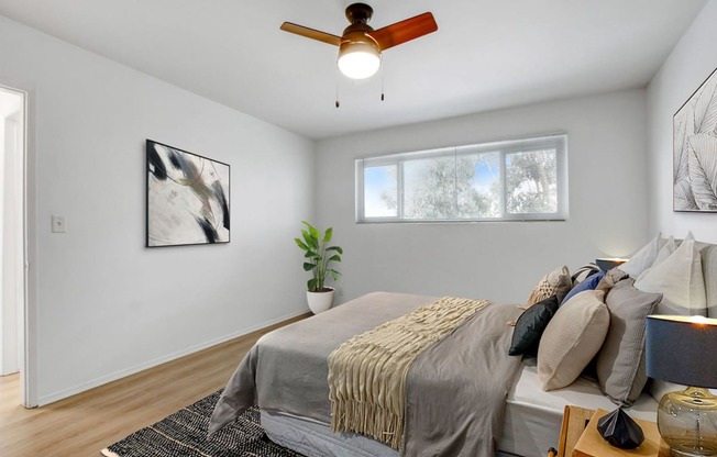 a bedroom with a large bed and a ceiling fan