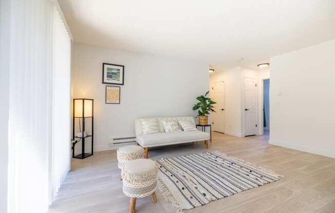 a living room with a couch and a rug at Campbell West Apartments, Campbell, California