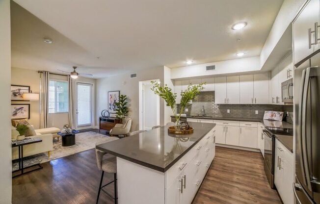 Model kitchen with white cabinetry and island