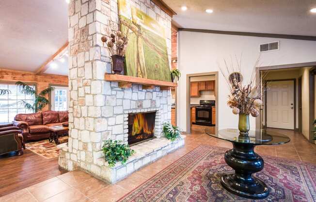 a large stone fireplace with a large painting above it