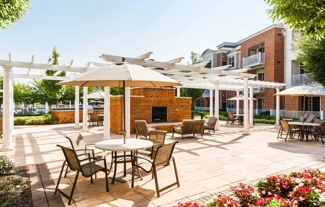 a patio with tables and chairs and umbrellas