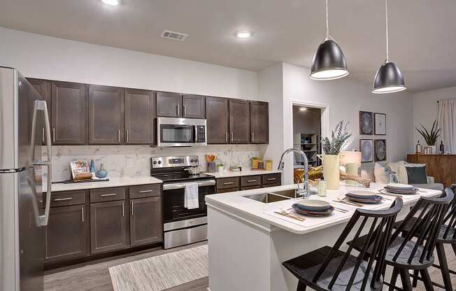 Modern kitchen with dark brown cabinets and stainless steel appliances at Edge and Stone, San Antonio, TX, 78260