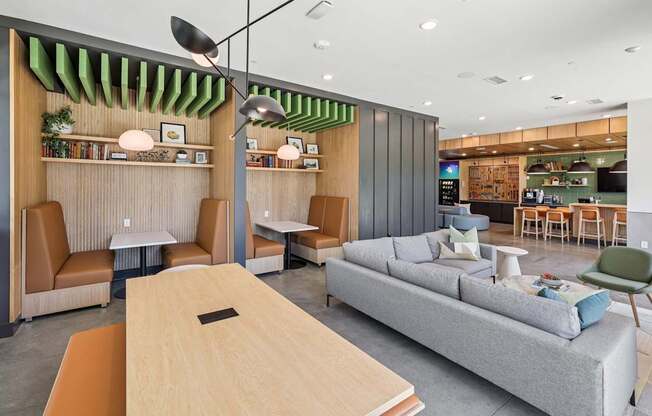 A modern living room with a grey sofa, wooden table at Link Apartments® CYKEL Apartments, North Carolina