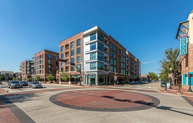 A roundabout in front of a building with a sign that says "Downtown.".