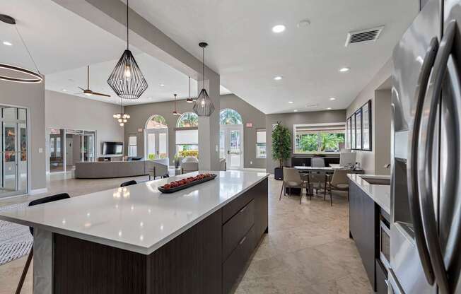 A modern kitchen with a large island and stainless steel appliances.