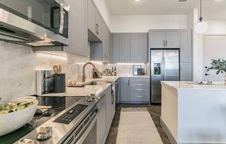 Apartment interiors boast wood plank flooring, quartz countertops and backsplashes, high-end finishes, and the latest in energy-efficient appliances.
