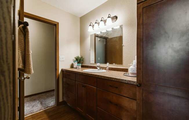 Grand Forks, ND Grandview II Apartments. A bathroom with a sink and dark cabinets