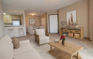 A living room with a white couch, a wooden coffee table, and a ceiling fan.