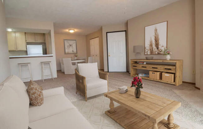 A living room with a white couch, a wooden coffee table, and a ceiling fan.