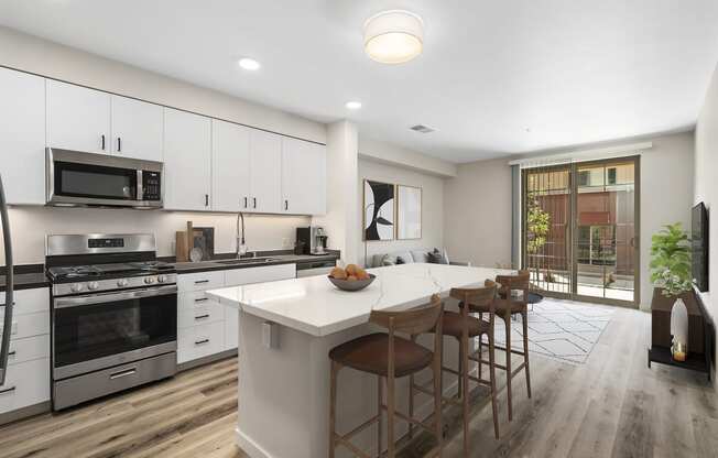 a kitchen with white cabinets and a large island with a white countertop