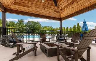 A wooden deck with chairs and a table.