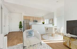 a living room and kitchen with a couch and a table