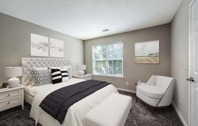 a bedroom with a bed and a chair