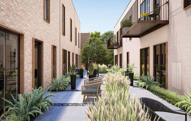 a courtyard with benches and plants outside of a building