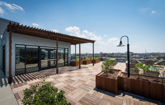 a roof terrace with a view of the city