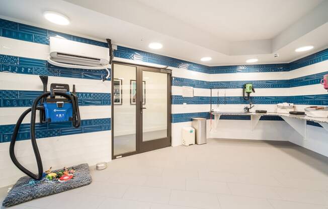 a pat spa with a shower and sinks and a blue and white striped wallpaper at Magnolia Square, Florida, 34109