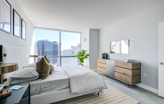 a bedroom with a bed and a large window