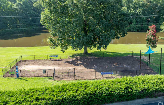 A playground with a swing set and a tree in the background.